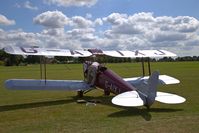 G-AIXJ @ EGTH - 1942 Tiger Moth on show at the 'Gathering of Moths' 2019 at Old Warden with its owner working under the cockpit seat - by Chris Holtby