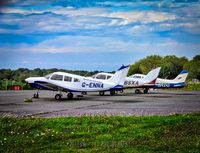 G-ENNA @ EGKB - A trio of Piper Warrior IIs parked at Biggin Hill airfield. - by Yellow 14 Photography