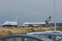 9V-SFK @ EHAM - With BA A320 G-EUUS
