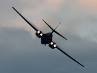 86-0126 @ KOSH - Rear view of USAF B-1B AF 86-0126 Cn 86 starting a Dusk ‘Afterburner Vapour Run’, with wings swept forward. Photo taken at the start of the Night Airshow, at Air Venture Oshkosh KOSH on 26Jul2017. Vapour is forming on the wings as the aircraft accelerated - by Walnaus47