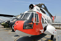 1429 - On the deck of USS Intrepid, in front of an H-19 and AH-1J.  The U.S. Coast Guard selected the commercial S-62 single turbine helicopter for rescue operations. - by Arjun Sarup