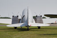 N144WC @ KOSH - Parked in the warbirds area at AirVenture 2019. The rear view shows the remodelled nacelles with twin exhausts from the PW Canada turboprops. - by alanh