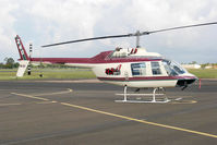VH-SLT @ YBUD - Stbd side view of Bell 206B-3 JetRanger III VH-SLT Cn 3072 Code 240 at Bundaberg Airport YBUD on 14Jan2004. The helo wore a ‘93.9 Hitz FM’ Logo for a sponsoring Queensland Radio Station, and Code ‘Firebird 240’. - by Walnaus47
