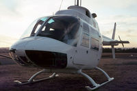 VH-FJR (1) @ YSCN - Close cropped view of the cabin of Bell Helicopter Australia (BHA) white-skin Demonstrator Bell 206A JetRanger VH-FJR Cn 168. Photo taken just before sunset at Camden Airport, YSCN, on 20Aug1970. The helo was fitted with a Nite-Sun searchlight.