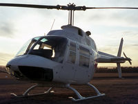 VH-FJR (1) @ YSCN - Close cropped silhouette view of Bell Helicopter Australia (BHA) white-skin Demonstrator Bell 206A VH-FJR Cn 168. Photo taken just before sunset at Camden Airport, YSCN, on 20Aug1970. The helo was fitted with a Nite-Sun searchlight.