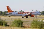 G-EZWD @ LFBD - Airbus A320-214, Reverse thrust landing rwy 05, Bordeaux Mérignac airport (LFBD-BOD) - by Yves-Q