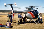 VH-JBE @ YCOM - Hughes 369E VH-JBE Cn 0148E being inspected  on static display at Cooma Airport YCOM, during the 'Snow Opening' Airshow on 11May1986. The helo was previously USA Registered as N5229J, and was being operated for U.A.A. Films Limited in Sydney in Nov 1985. - by Walnaus47