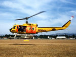 VH-NSH @ YSCB - Low res Port side view of hovering NSCA Bell 205A-1 VH-NSH Cn 30195 Code 01 at Canberra Airport YSCB on 17Mar1986. This Helo wears a 'Country Fire Authority' logo and is equipped with a water tank and filler hose, for Fire-fighting duties - by Walnaus47