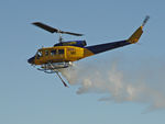N234PH @ YBUD - Portside view of McDermott Aviation Bell 214B-1 Biglifter N234PH Cn 28050 flypast ‘water-dump’ at Bundaberg Airshow at Bundaberg Airport YBUD on 17Jul2005. Equipped with ‘under-cabin’ water tank, with ‘pick-up’ hose extended.