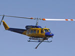 N234PH @ YBUD - Front Stbd view of McDermott Aviation Bell 214B-1 Biglifter N234PH Cn 28050 flypast at Bundaberg Airshow at Bundaberg Airport YBUD on 17Jul2005. Equipped with ‘under-cabin’ water tank, with ‘pick-up’ hose extended.