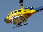 N234PH @ YBUD - Rear Port underside view of front end of McDermott Aviation Bell 214B-1 Biglifter N234PH Cn 28050 hovering at Bundaberg Airshow at Bundaberg Airport YBUD on 17Jul2005. Equipped with ‘under-cabin’ water tank, with ‘pick-up’ hose extended.
