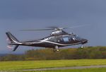 N109TF @ EGKB - Agusta A109 landing at Biggin Hill against a very stormy sky - by Chris Holtby