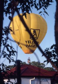 VH-NIK - VH-NIK over houses in West End, Brisbane - by Ted Johnson