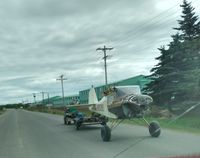 N95068 - Wingless, being towed by 4-wheeler on Alaska Peninsula Highway. Was being taken to AGS cannery yard, Naknek AK. - by Sean Wilson