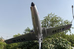 W1745 - Hemmed in by lampposts, trees and hedges at Shaheed Smarak Park, Noida, this Iskra should be effectively camouflaged in a few years.  The Iskra was inducted in the IAF in Oct. 1975 and served as a stage two trainer for many years. - by Arjun Sarup