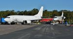 9H-AUL @ EGHH - At European Avn. with N623NP on scrap line behind - by John Coates
