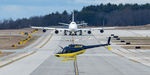 N868JB @ KPSM - Utility Line helo heads off after filling up while an Atlas 747 comes down the Alpha Taxiway - by Topgunphotography