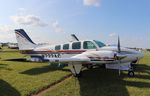 N722AG @ KOSH - Beech 58 - by Mark Pasqualino