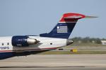 N709PS @ KSRQ - PSA Airlines/US Airways Express CRJ-700 backs from the gate at Sarasota-Bradenton International Airport - by Suncoast Spotter