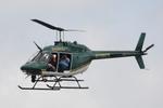 N106CS @ KPGD - Charlotte County Sheriff's OH-58 flies over the crowd at the Florida International Air Show - by Suncoast Spotter