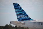 N3162J @ KRSW - JetBlue A220 parked on the north ramp at Southwest Florida International Airport