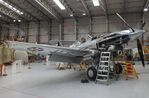 G-CIIO @ EGSU - Curtiss P-40C Warhawk undergoing maintenance at the IWM and other collections, Duxford - by Ingo Warnecke