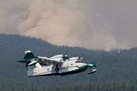 C-FAFN - A Scooper aircraft fighting the Rice Ridge Fire in early August 2017, one of four on location that day. Heavy wildfire smoke rising from behind the ridge in the background. - by Mark Melvin