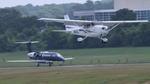 N6867Z @ KPDK - Wheels Up Phenom 300 with Skyhawk landing in foreground - by AviationLover50