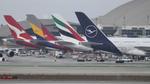 D-AIMC @ KLAX - Lufthansa, Emirates, Asiana and Qantas A380s parked at the LAX international terminal. The wing of a Lufthansa 747-8 is also visible to the left.