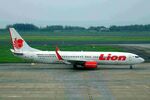 PK-LHI @ WAHI - Lion B737-900ER with Lion parcel.com-titles on the engine taxies to the apron at Yogyakarta International, Indonesia - by Reinhard Jost