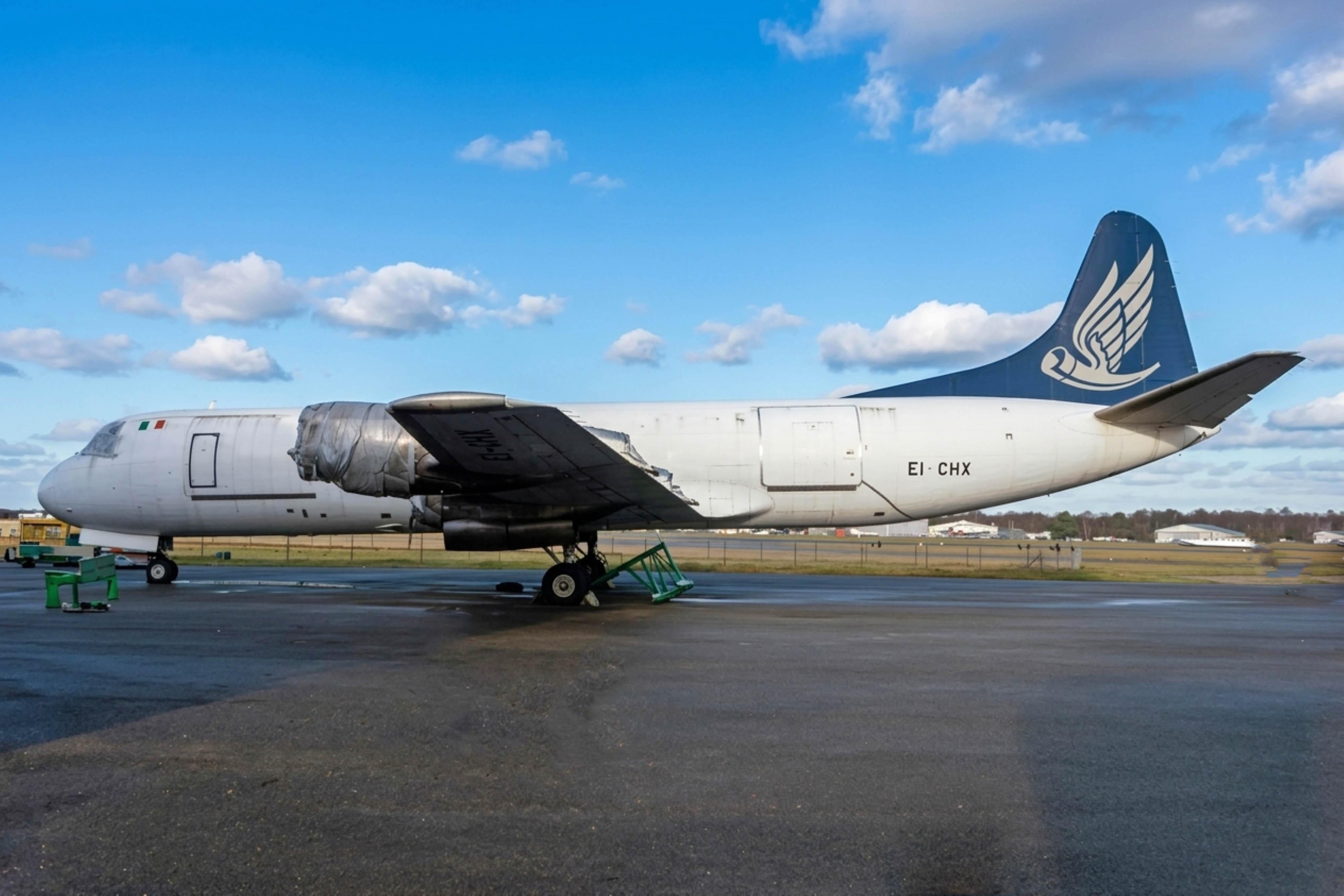 EI-CHX @ EGHH - EI-CHX 1959 L-188CF Electra Hunting Cargo Arlines BOH  - by PhilR