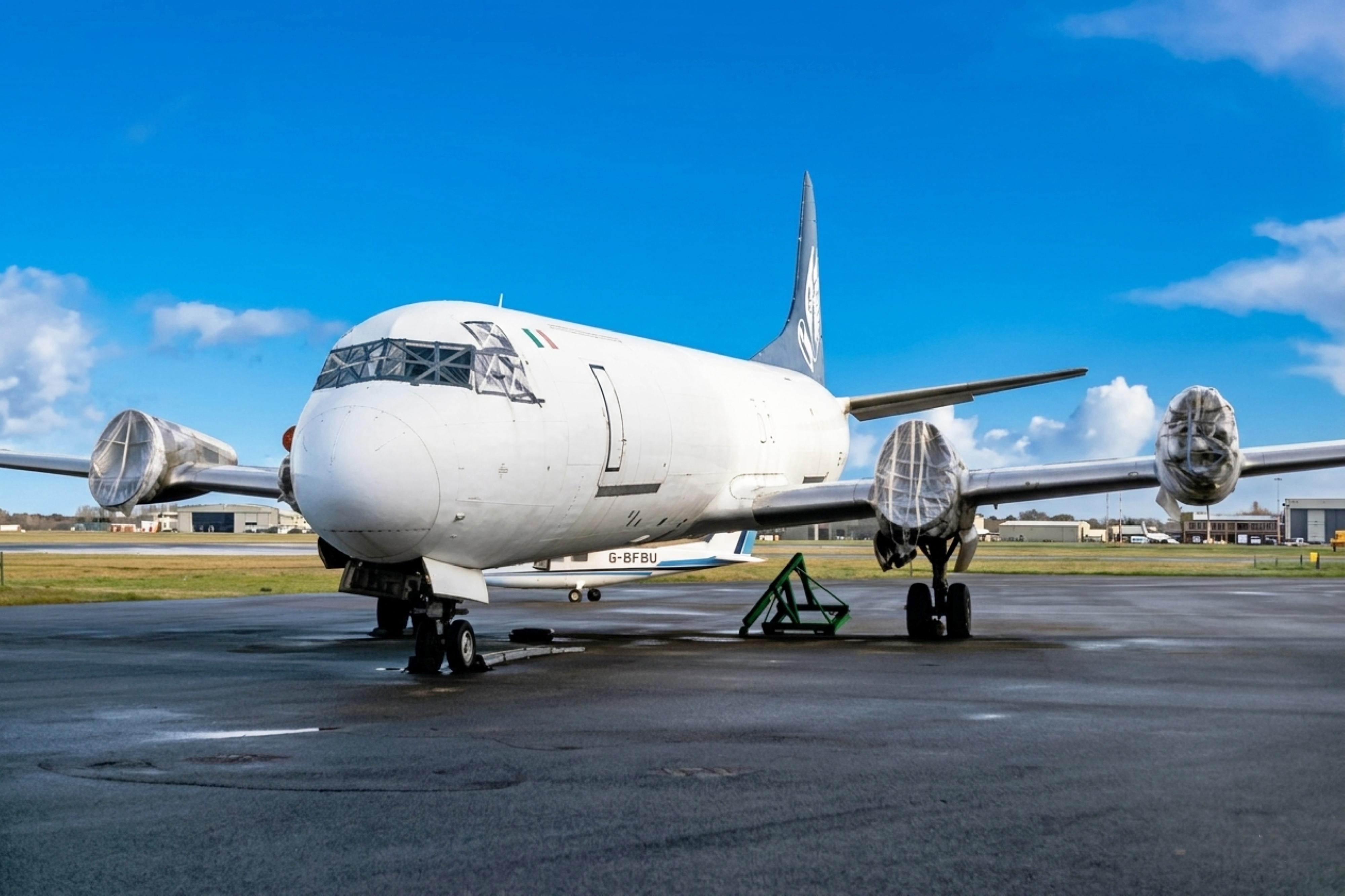 EI-CHX @ EGHH - EI-CHX 1959 L-188CF Electra Hunting Cargo Arlines BOH  - by PhilR