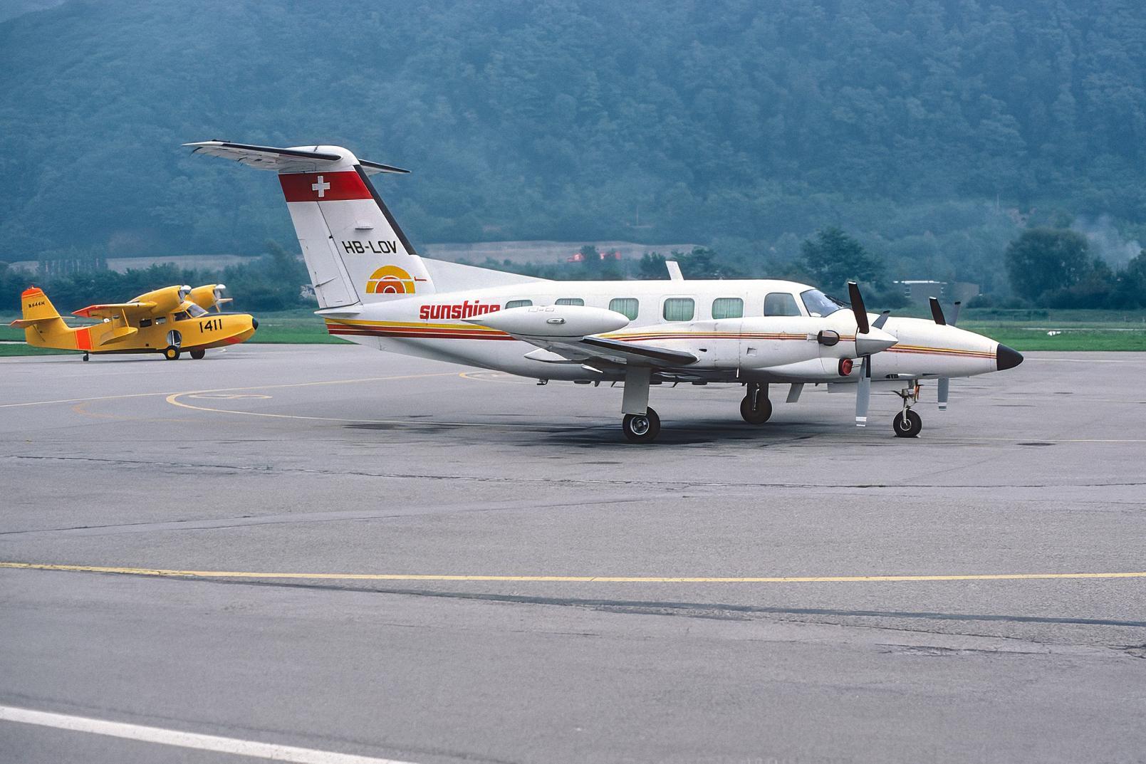 HB-LOV @ LSZA - Parked at Lugano-Agno airpoert. Scanned from a slide. - by sparrow9