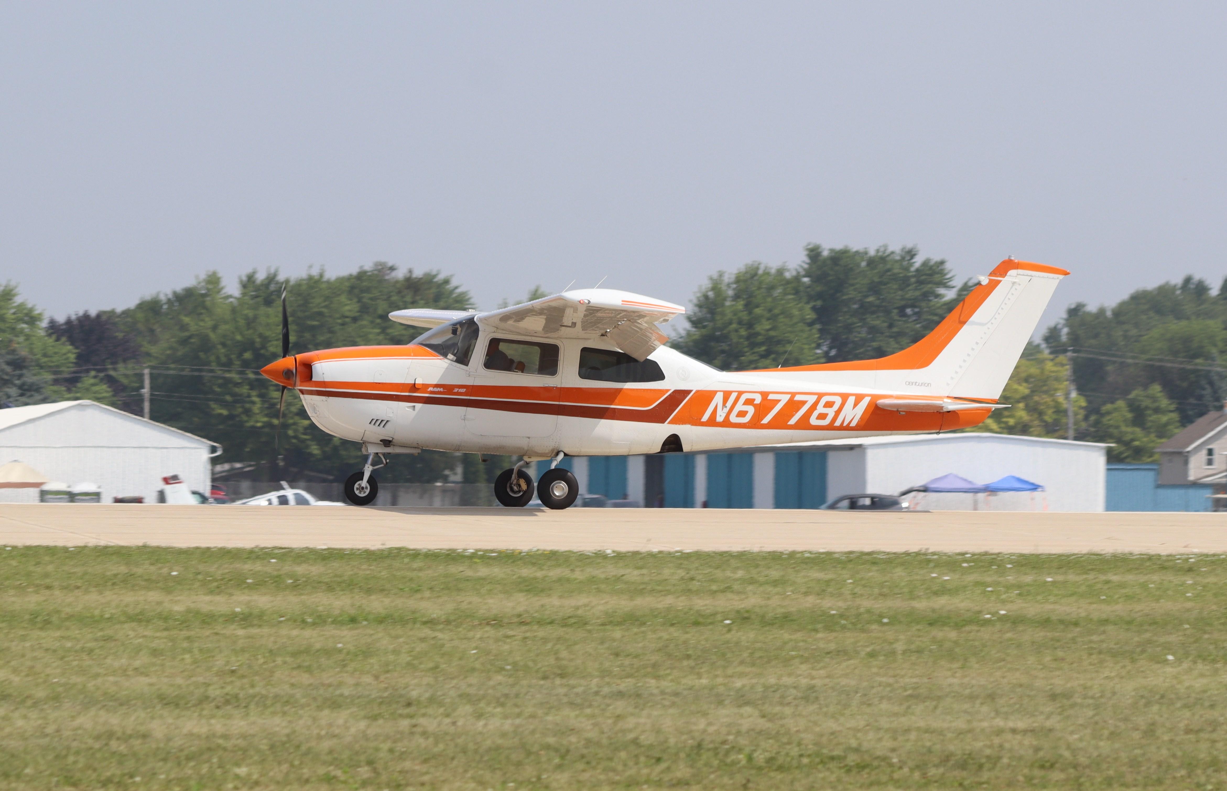 Aircraft N6778M, Cessna 210M, at KOSH, photo by MarkPasqualino