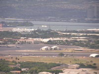  - Hickam AFB ramp at Honolulu Intl Airport. Arizona Memorial in background. Taken on final to rnwy 8L - by John J. Boling