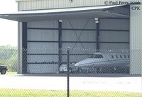  @ Chesapeake Regional Airport - Biz-Jet poking her nose out of the hangar a bit - by Paul Perry