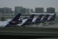  - The FedEx terminal late in the evening at LAX is full. I count 7 aircraft just on this side. There are more to the right that are out of view. - by Dean Heald