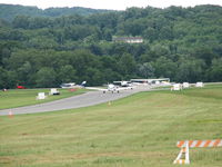  - This was the line for departure from the 2006 AOPA Fly-In.  If that was my house I would have a deck on the roof and sit and watch the antics on the runway everyday.  FDK is MD's second busiest airport that makes for some pretty good antics. - by Sam Andrews