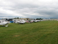  - Another view of the transcient flight line on AOPA Fly-in day.  The guys and gals in the red vests were giving out some dandy service directing traffic - by Sam Andrews
