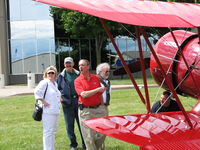  - One of the icons of the airport. Phil Boyer; Pres. AOPA (red shirt) checking out one of the former AOPA sweepstakes planes that flew in for the 2006 AOPA Fly-In. - by Sam Andrews