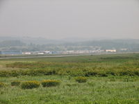  - Looking across the airport grounds from west to east.  Look closely and you can see a B-17 taxiing out for takeoff. - by Sam Andrews