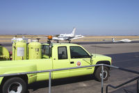 - Airport truck and visiting plane - by Bill Larkins