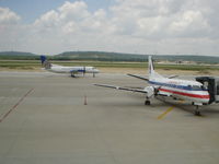  - A Colgan Air Saab 340 taxies to the runway for a flight to IAH, while a American Eagle Saab 340 is parked at the gate after a flight from DFW - by DPhelps