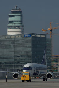  @ Vienna International Airport - LOT Boeing 737 pushing back infront of the office park and the control tower - by Yakfreak - VAP