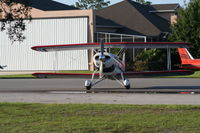  @ Spruce Creek Airport - Bi plane with private hangars in background - by Florida Metal