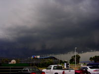  - Evening storm looking from Airport Parking lot toward speedway - by Florida Metal