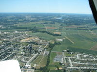  - Flying west and you can see the airport slightly right of center - by Herb Harris