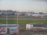  - Air Portugal A-319 on take off roll and BMI A-321 taxi in front of terminal 1 at Heathrow - by John J. Boling