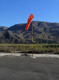  - Windsock, Runway 04 end of 04-22, Santa Clara Riverbed, South Mountain in background. Elevation: 2,263 ft. South Mountain marks the western terminus of the Santa Susana Mountain Range. - by Doug Robertson