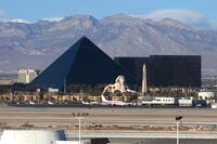  - Looking west from the airport's main parking structure, you get a nice view of the Luxor Hotel & Casino and the mountains. - by Dean Heald